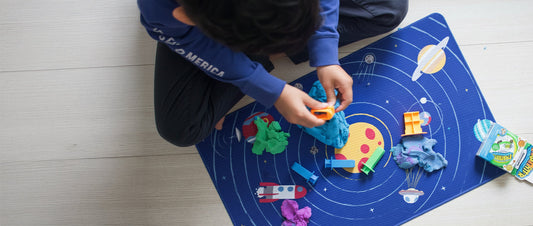 Teacher guiding children using Mad Mattr during classroom sensory play